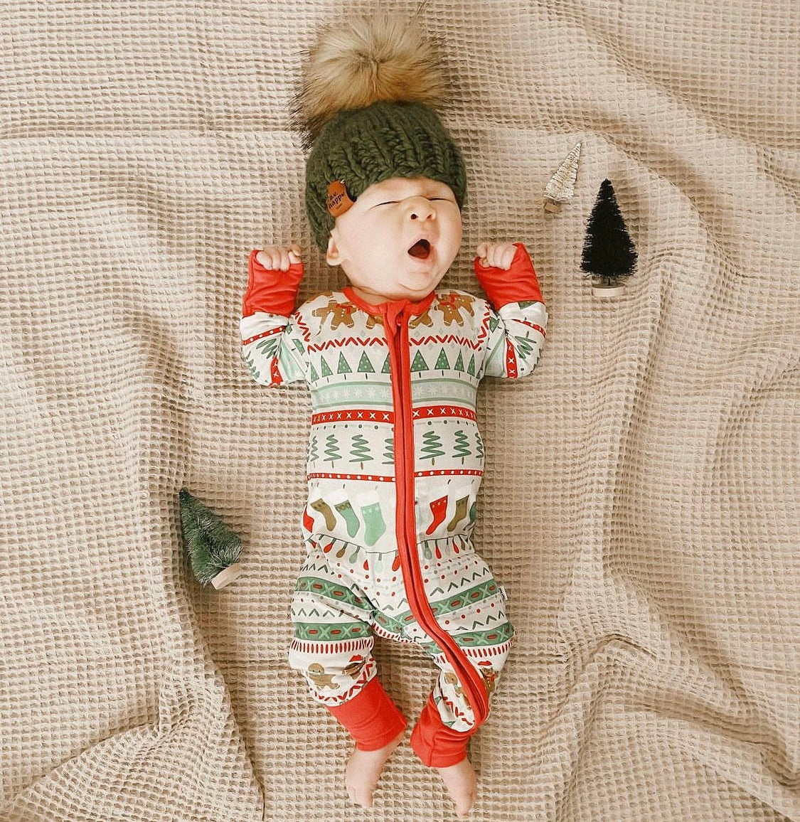 Baby in beanie with christmas jammies