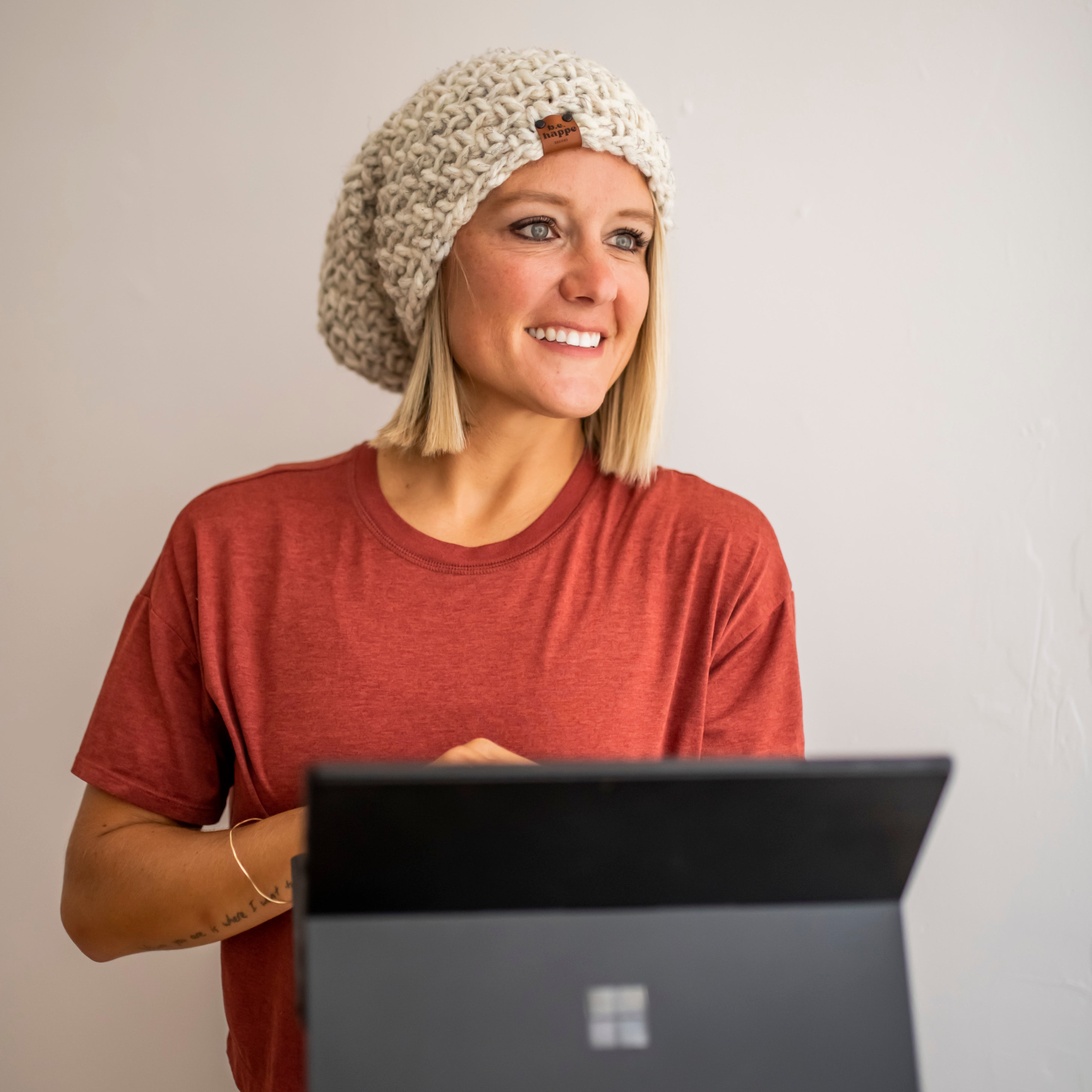 Brooke Happe wearing a natural colored women's slouchy beanie with tee