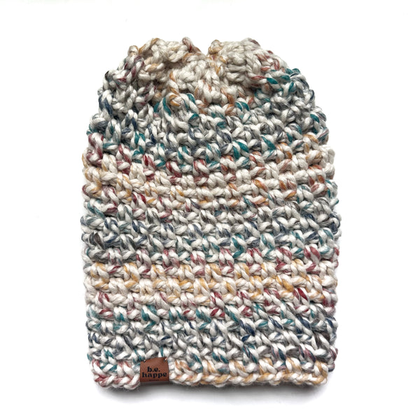 Multicolored knitted dog sweater on a white background
