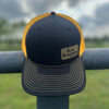 black and yellow trucker cap with behappe branded patch