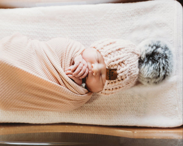 pink knit baby pom beanie that is perfect for baby shower gift 