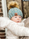 baby in blue heart hat