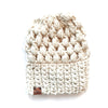 A cream-colored slouchy beanie with a puff stitch design and a thick crochet band, displayed against a white background.