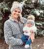 Mommy and me winter knit pom pom hats, matching mom  and son winter beanie with pom pom, handcrafted knit winter pom pom hat mother holding matching baby son