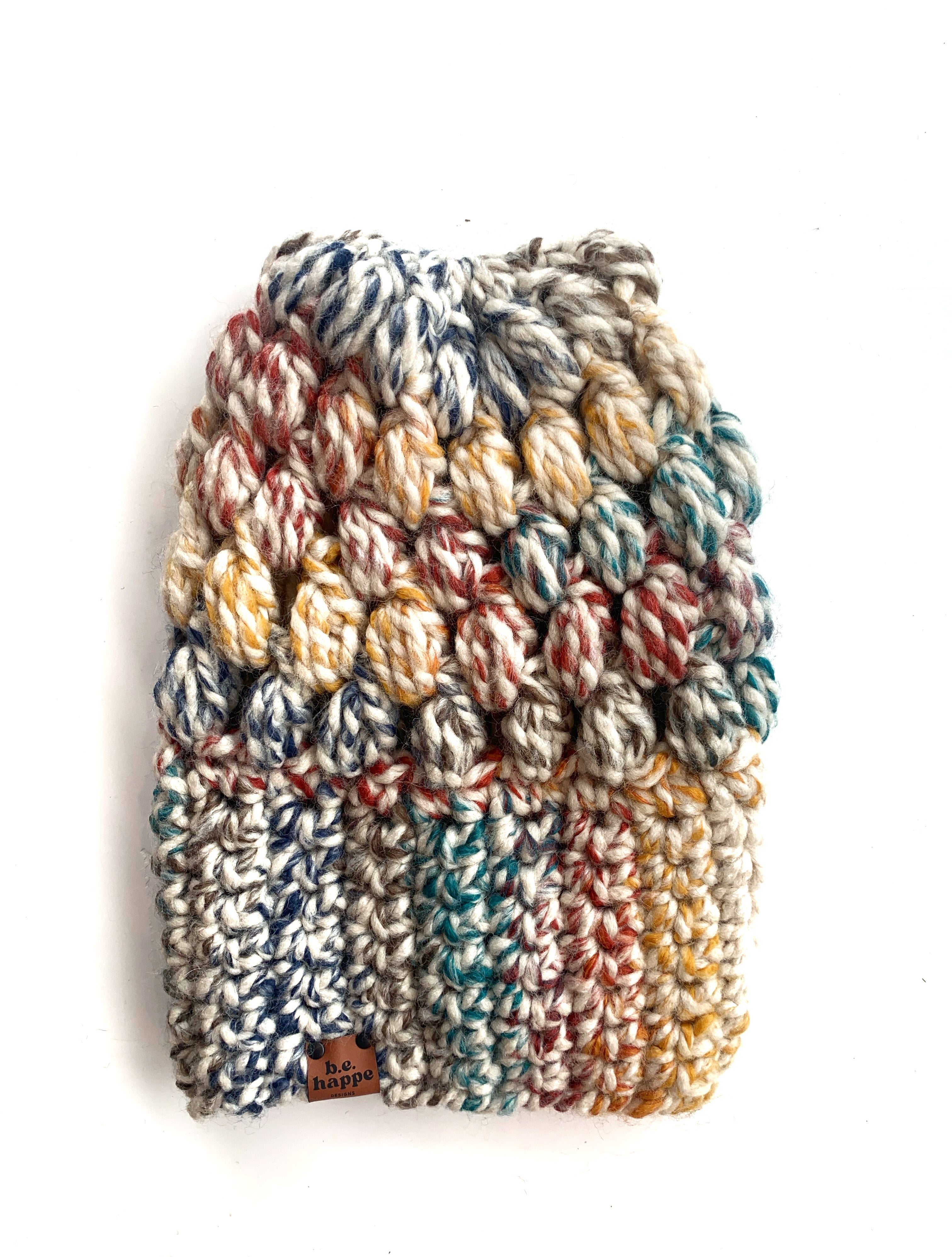 A multicolored crochet slouch hat with a puff stitch pattern, displayed against a white background.